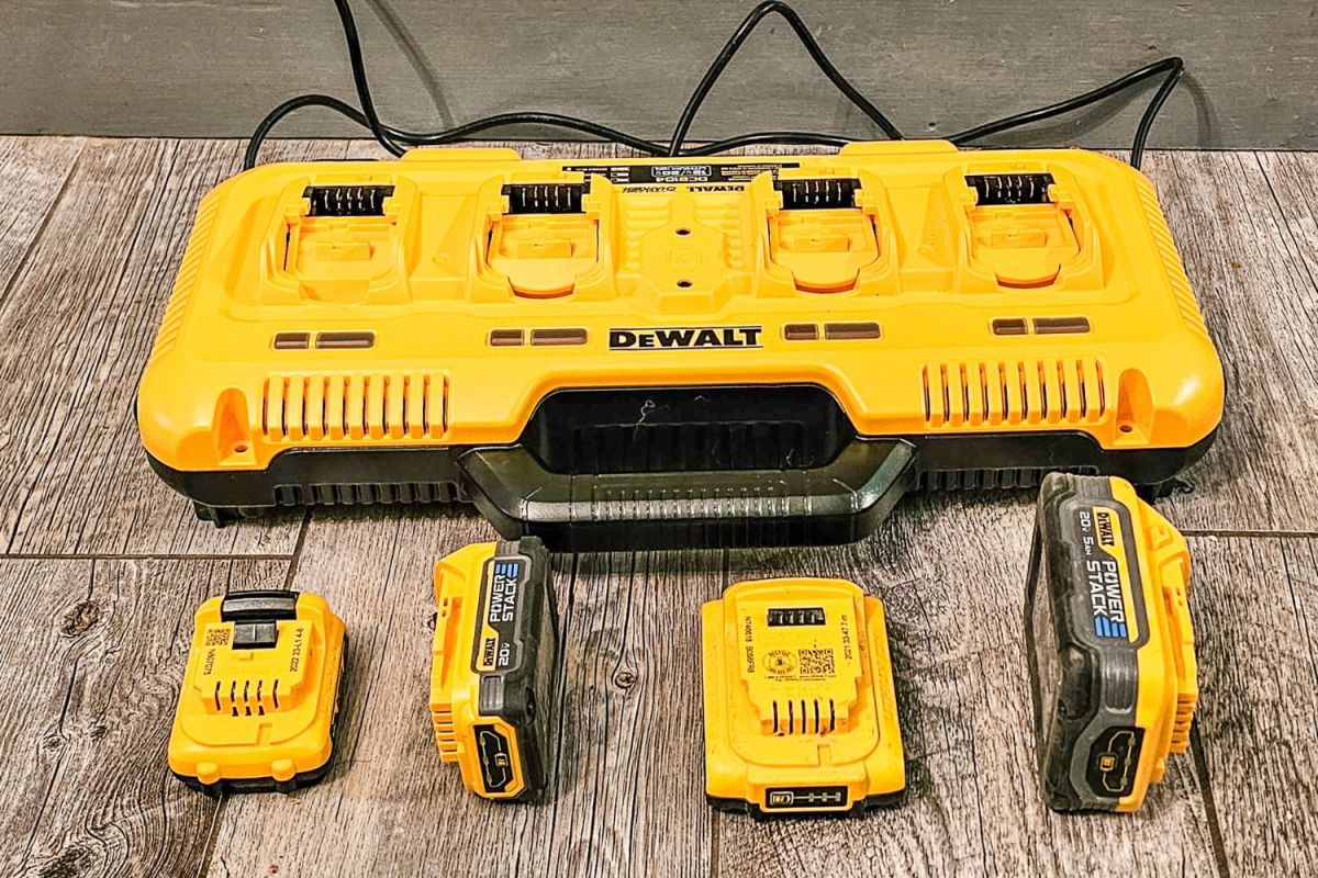 The Dewalt charging station with four different battery types next to it before testing.
