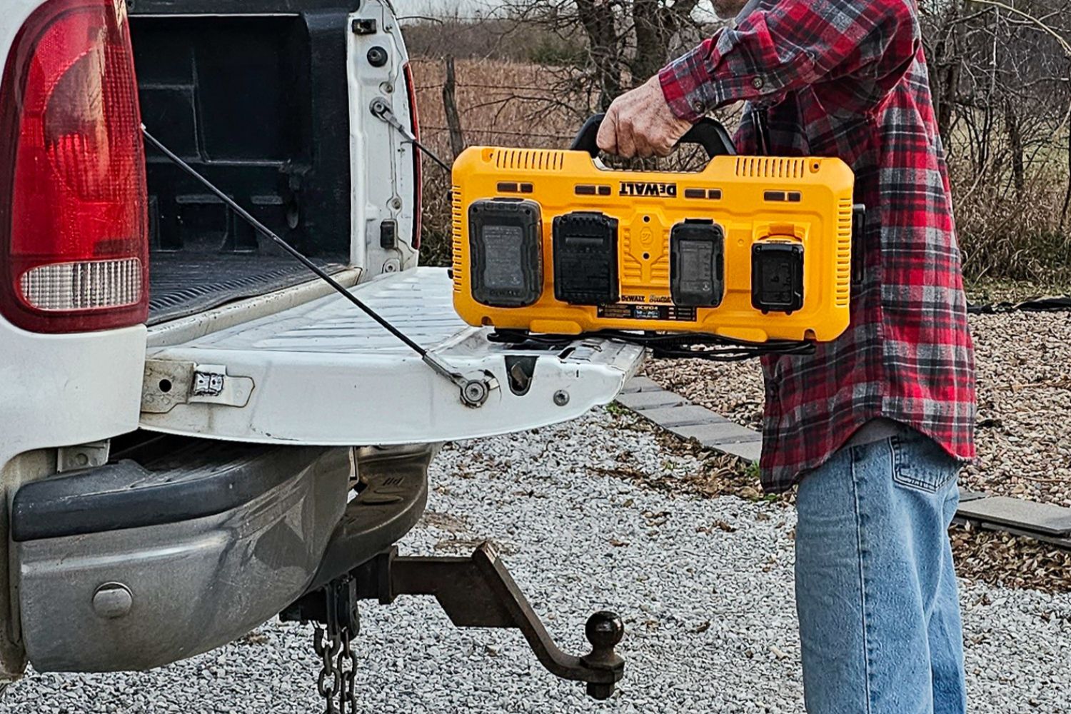 The Dewalt Charging Station with several power tool batteries plugged in for charging while getting loaded into a truck bed.