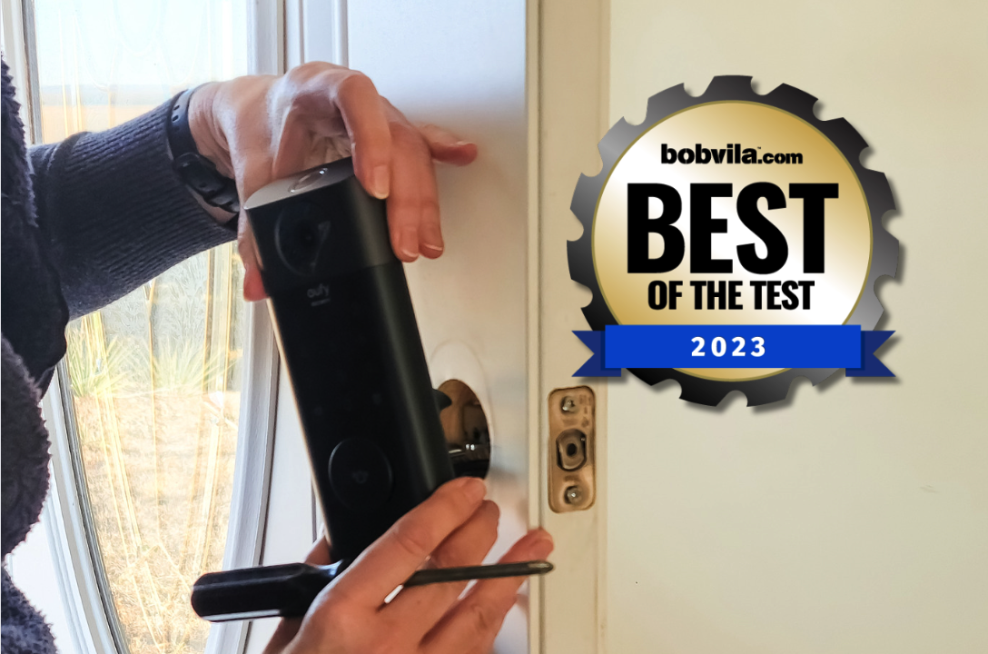 A person installing a smart lock onto a door
