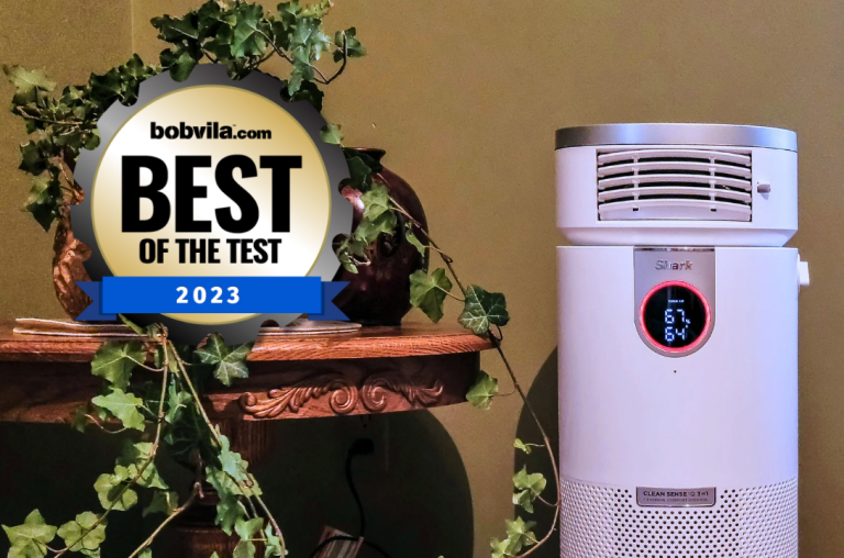Air purifier set up in a room next to a house plant