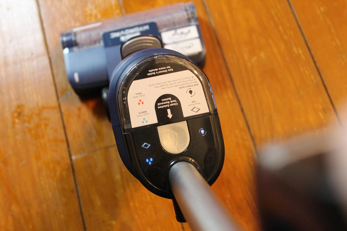 A person using the Shark HydroVac to clean hardwood floors.