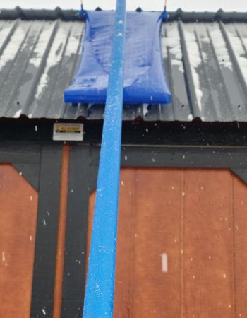 The Avalanche! Roof Rake undergoing testing pulling light snow off a metal roof.