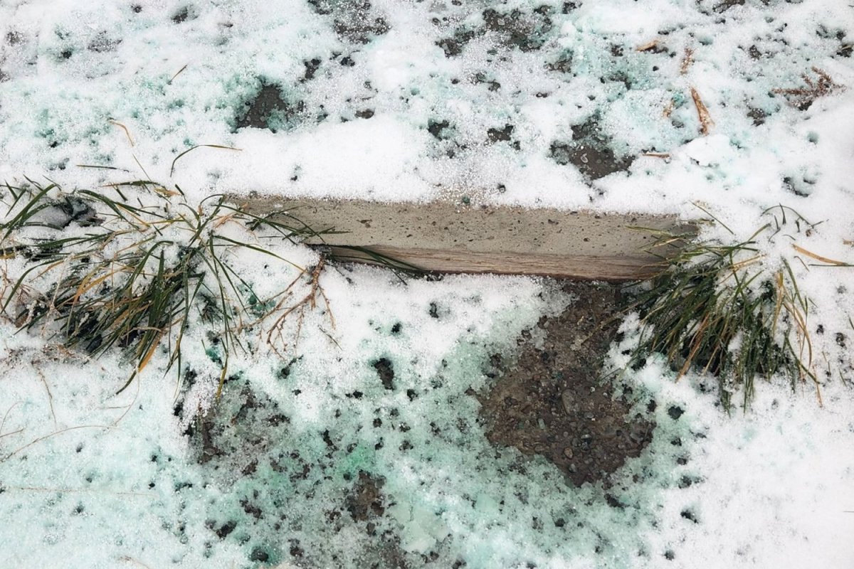 The Natural Rapport Pet-Safe Ice Melt melting the snow and ice on a sidewalk.