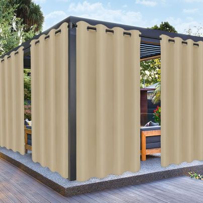 The PureFit Outdoor Curtain surrounding an elevated outdoor platform to give privacy to a dining area.