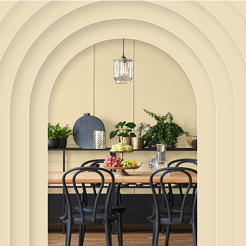 Dining room with arches painted in Glidden's Limitless yellow shade.