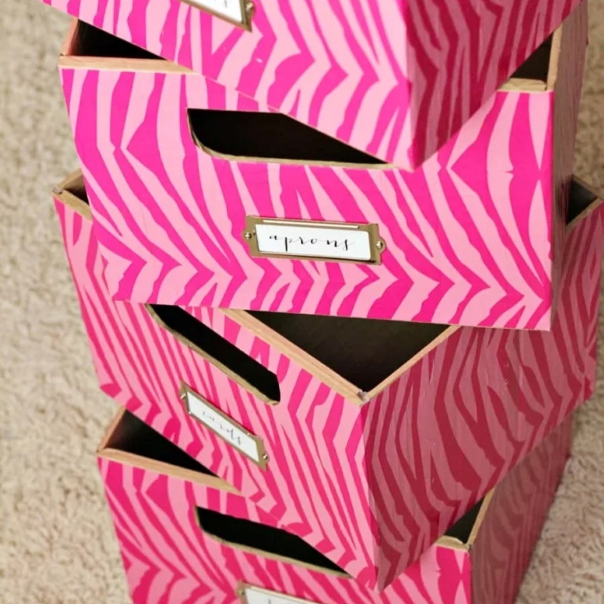 Stack of pink cardboard boxes.