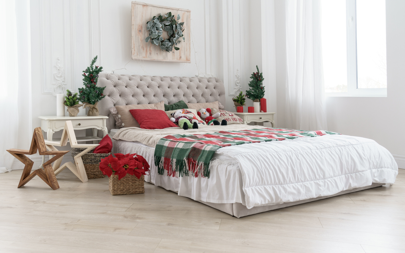 Decorated bedroom for Christmas holidays with trees and flowers