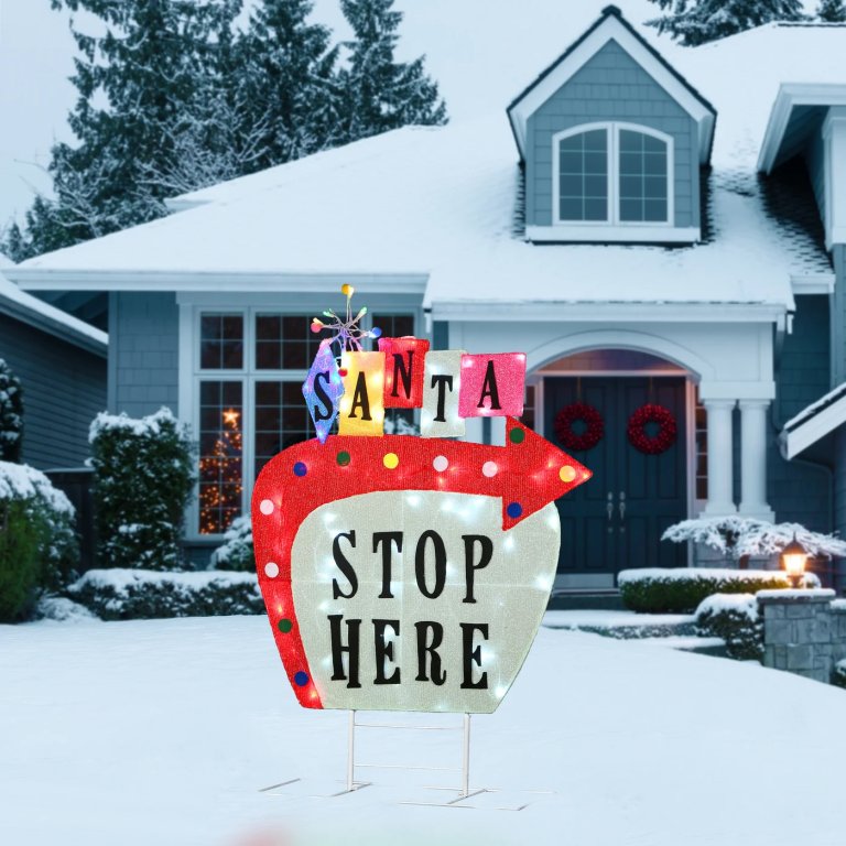 "Santa stop here" sign in front of a house.