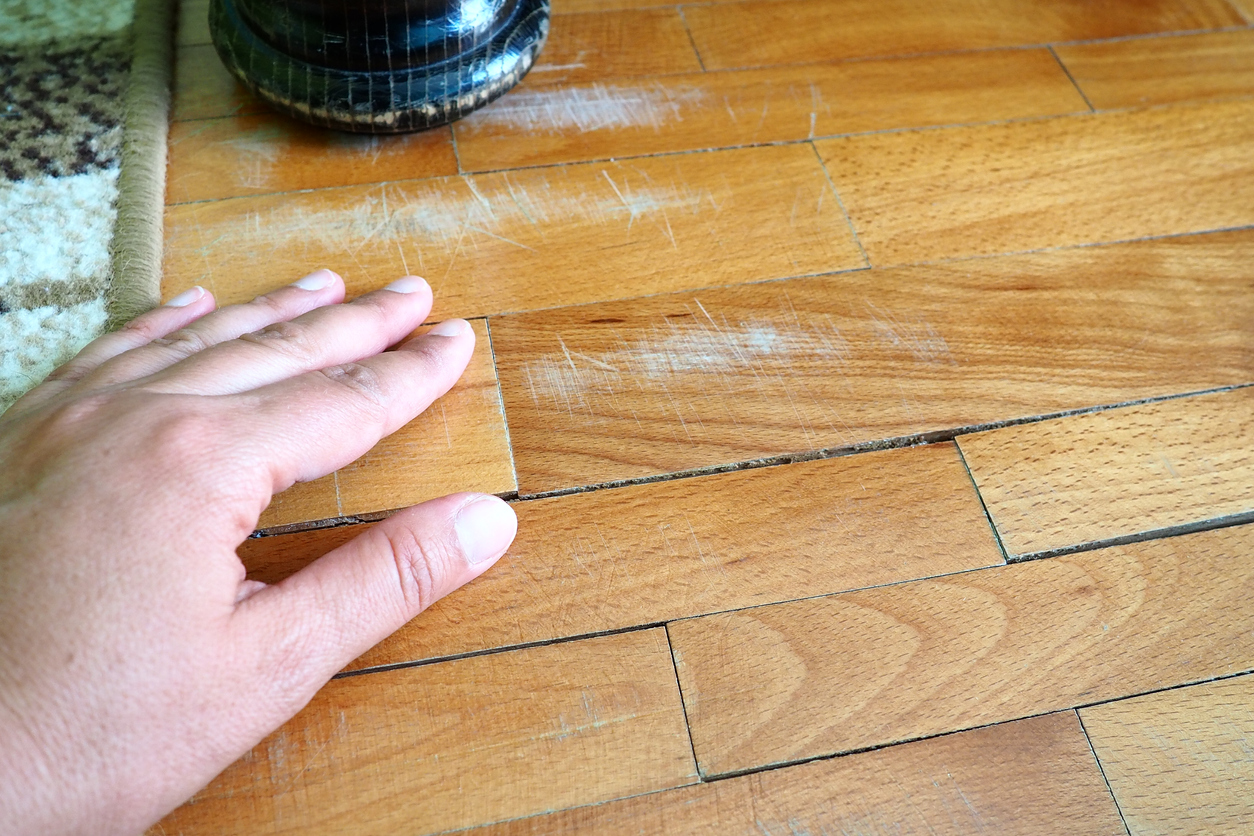 Assessing scratches on a wood floor.