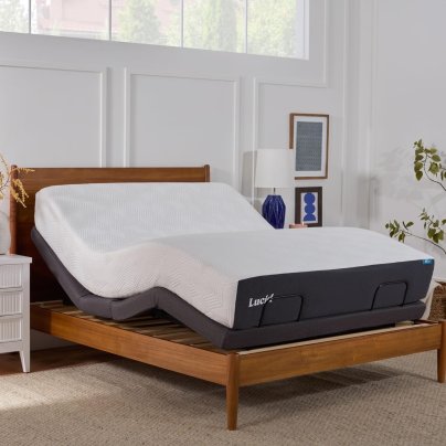 The Lucid L300 Adjustable Bed Frame set up against a feature wall in a bright white bedroom.