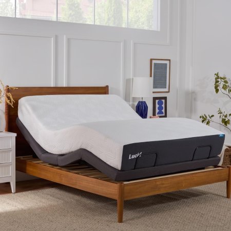  The Lucid L300 Adjustable Bed Frame set up against a feature wall in a bright white bedroom.