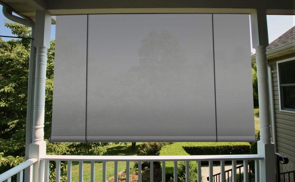 One of the best outdoor shades installed at the edge of a balcony patio to provide privacy from the yard.