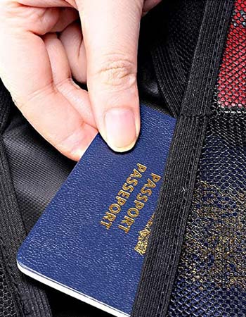 A person pulling their passport out of a pocket inside the Engpow Fireproof File Organizer Bag.