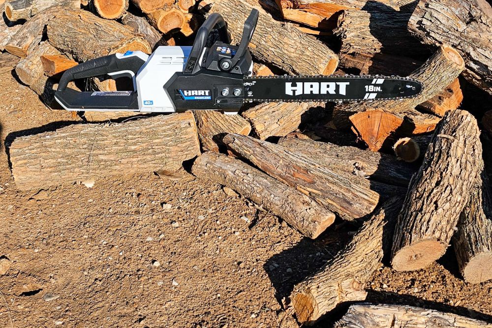 The Hart 40V chainsaw on a pile of cut logs during testing.