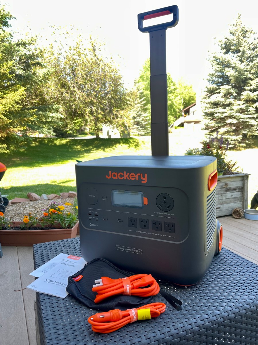 Jackery Explorer 3000 Pro sitting on outside table with accessories