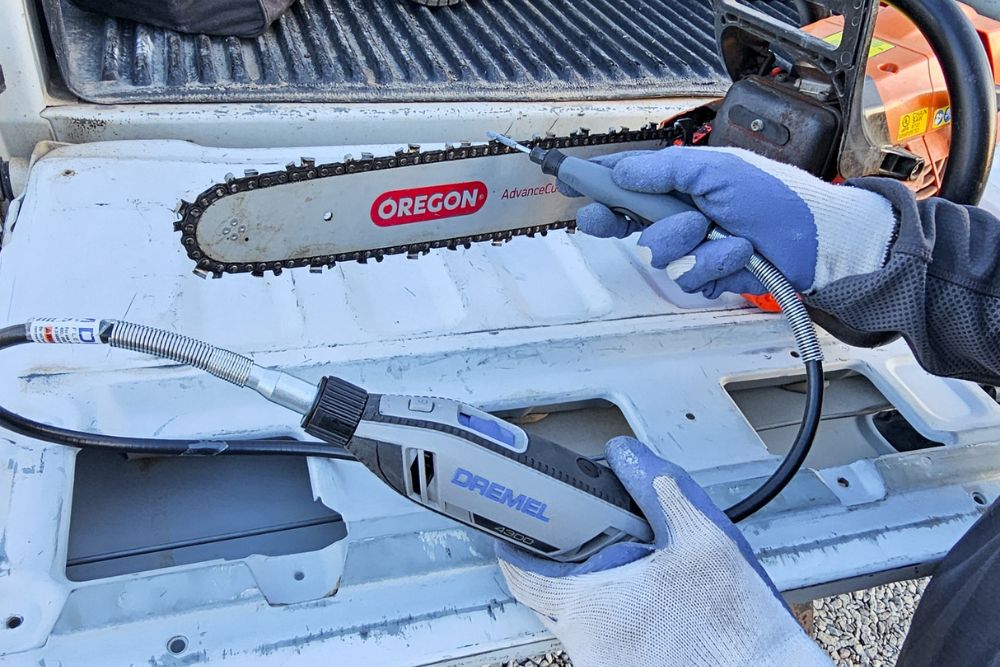 Person using Dremel rotary tool to sharpen Oregon chainsaw blade