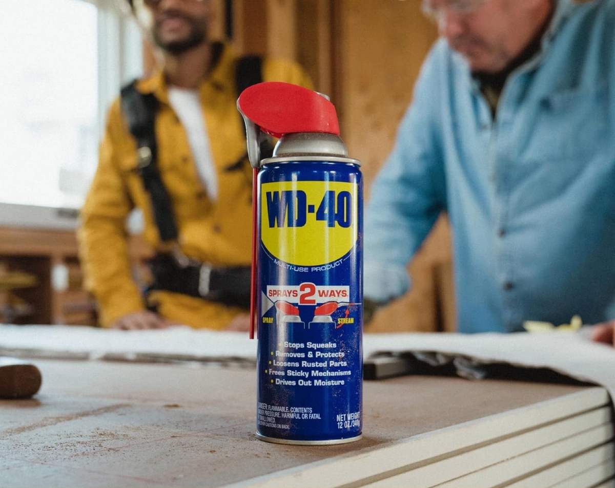 Can of WD40 with people in background.