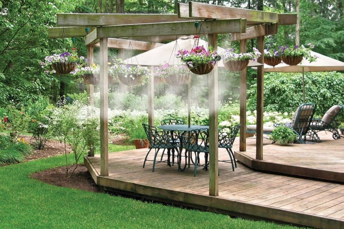 The Best Misting System set up around an outdoor seating area on a deck to cool the space and mist hanging plants.