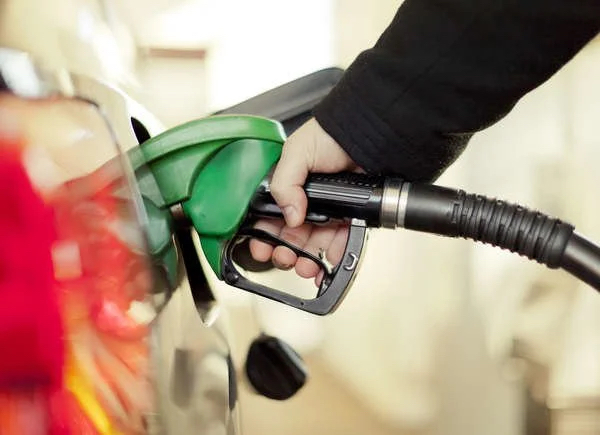 close up of person refilling gas tank