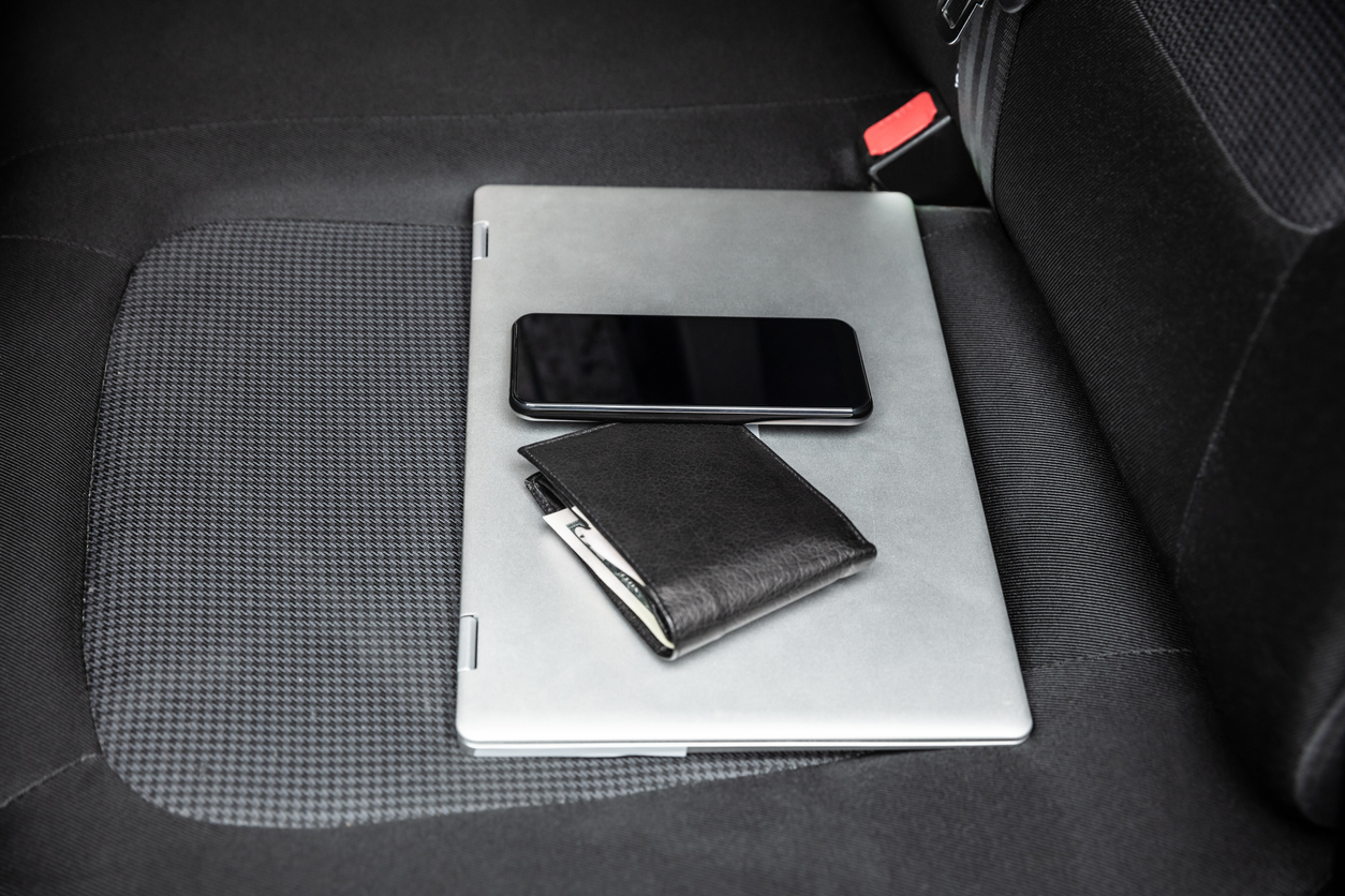Mobile Phone And Laptop On Car's Seat
