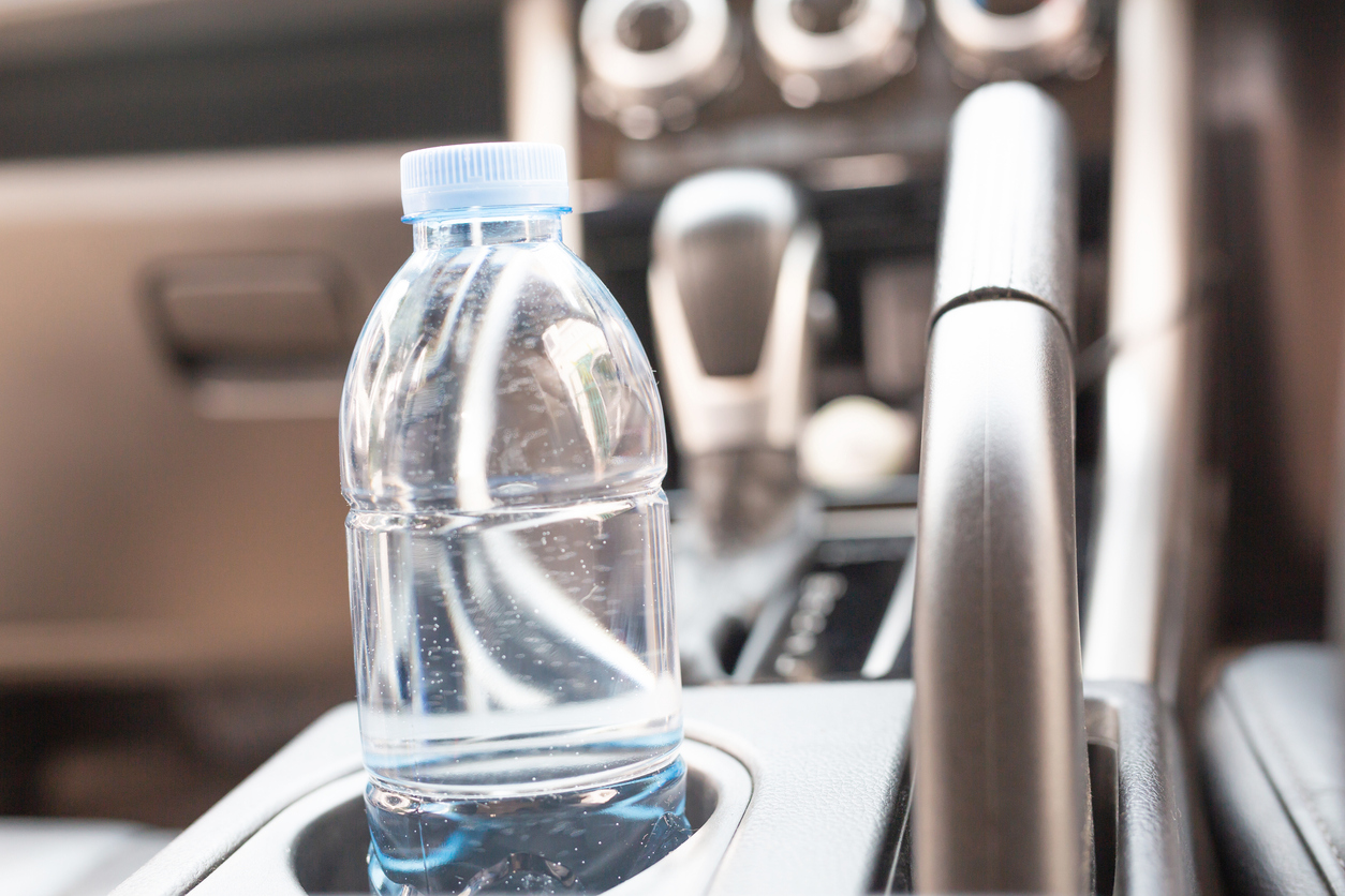 Drinking water in the car prepared for traveling