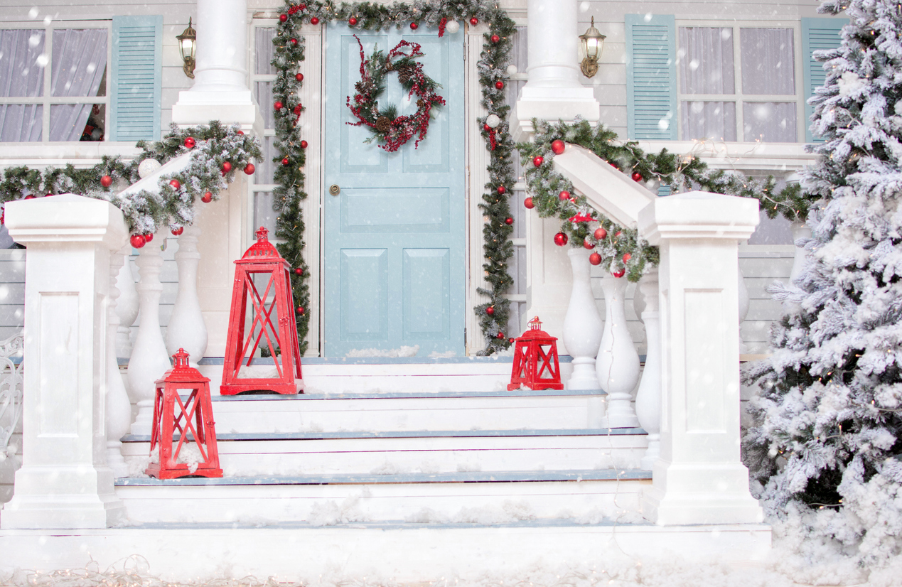 Snowy courtyard with Christmas porch, veranda, wreath, Christmas tree, garland,christmas balls and lanterns.
