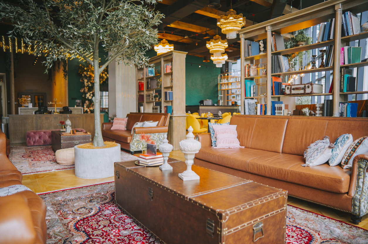 A-large-sitting-area-is-decorated-with-eclectic-furnishings-and-bookshelves.