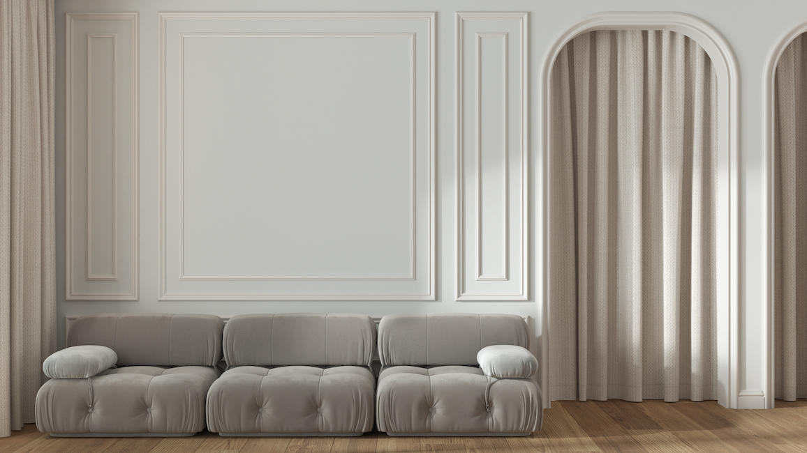 Tone-on-tone-living-area-in-sand-color-with-a-curtain-in-a-doorway.