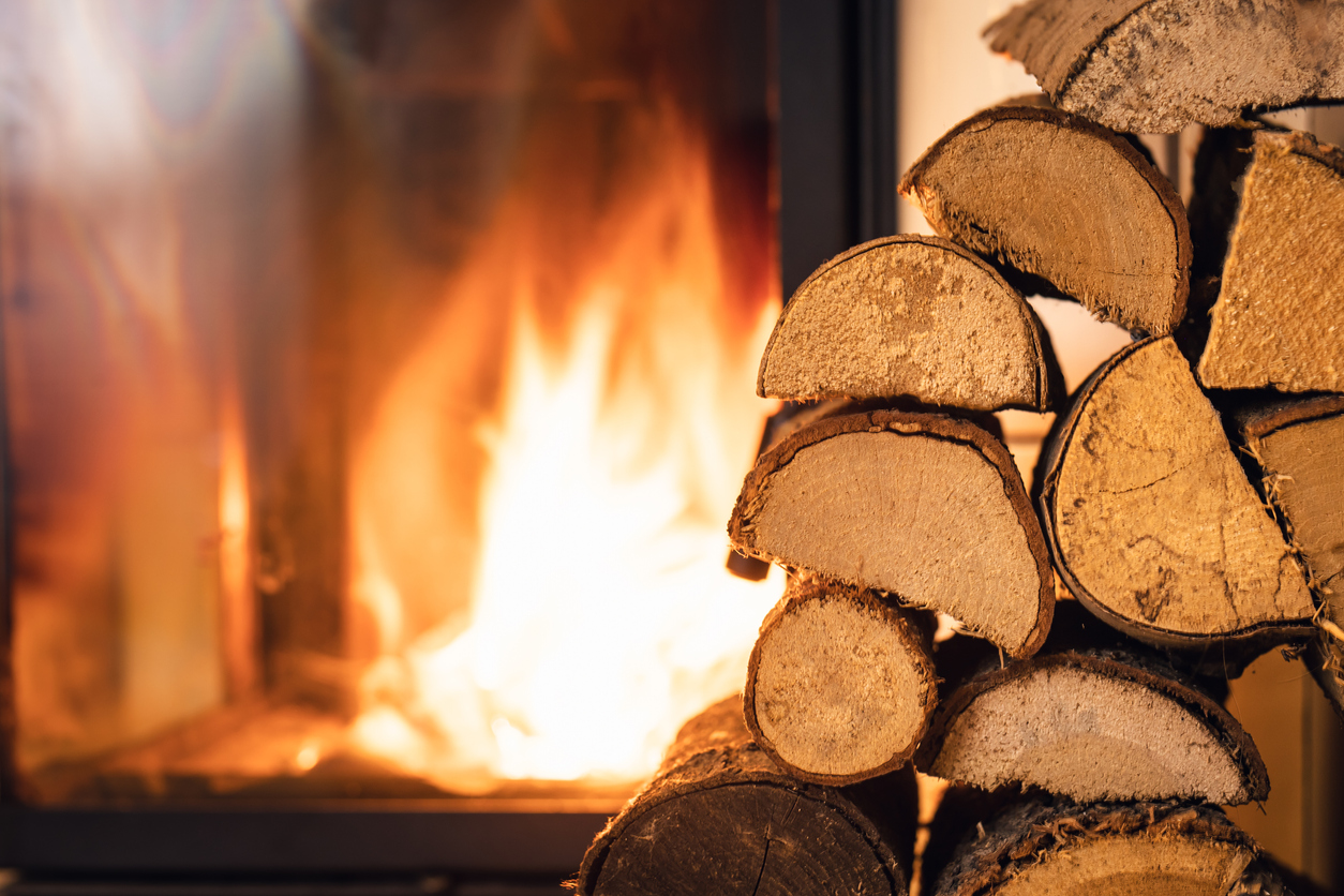 Firewood stack in front of fireplace.