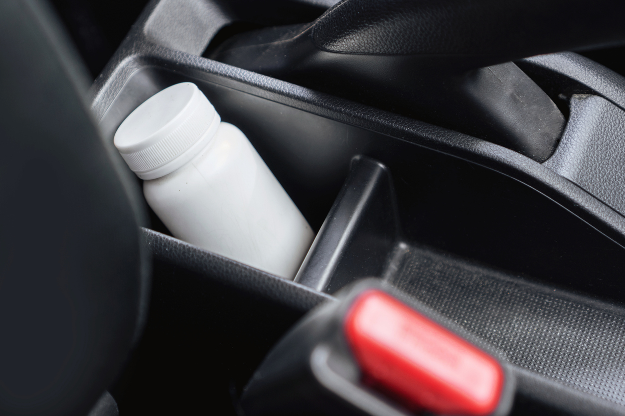 Closeup of Medicine Bottle Inside a Car , using medication before driving concept