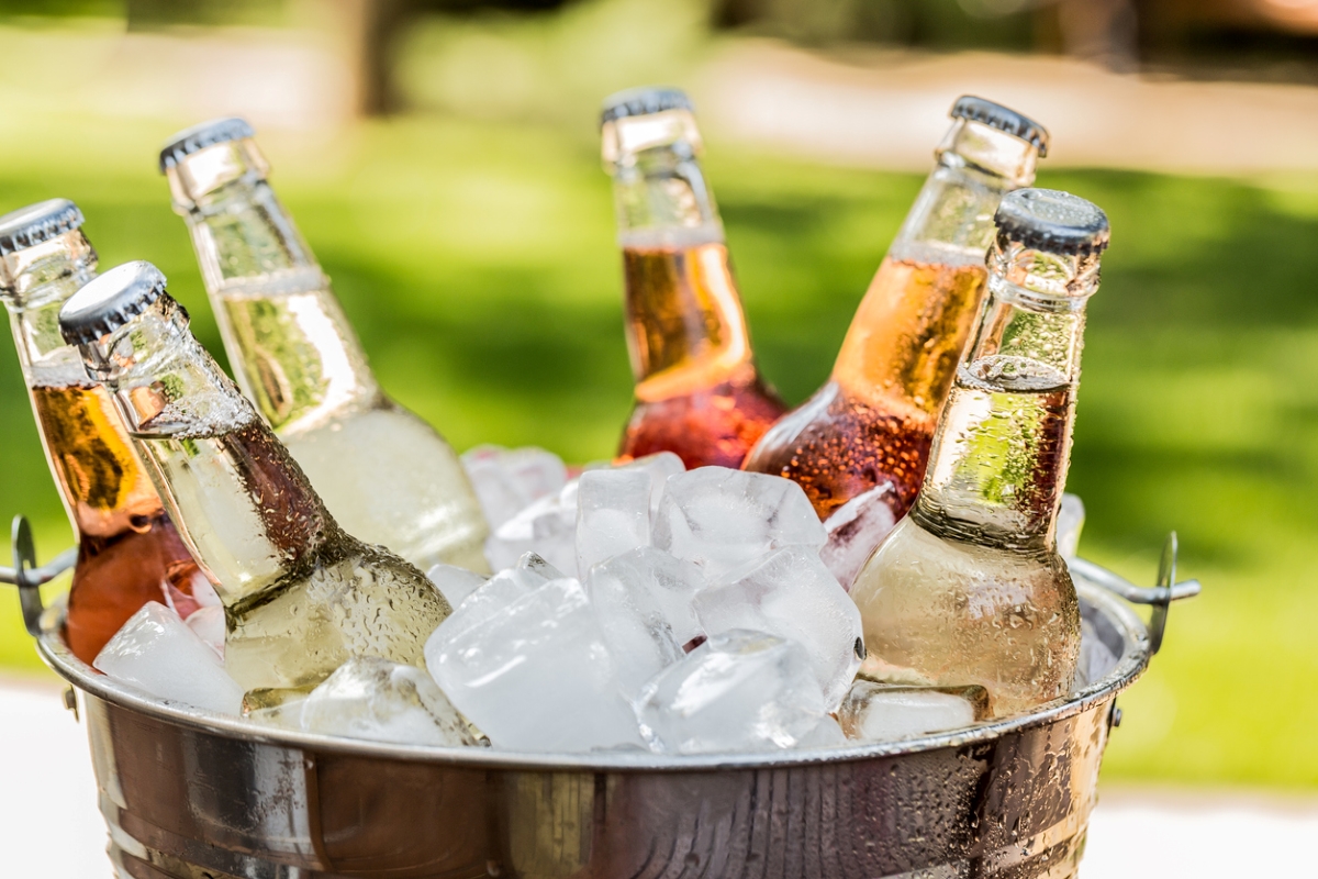 Bottled drinks in bucket of ice.