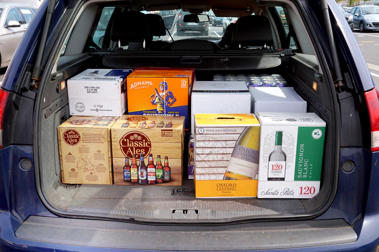 Car boot loaded with cheap beer and wine