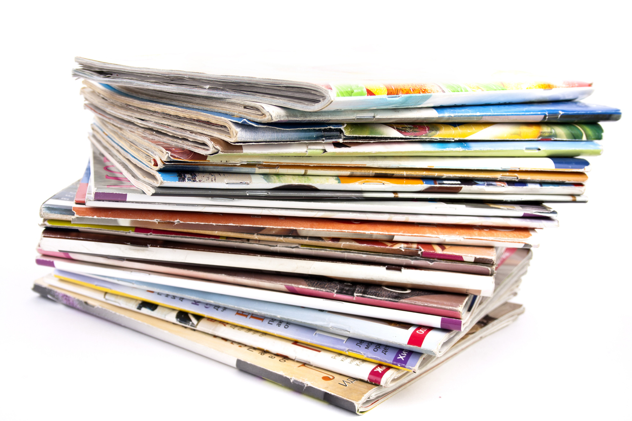 Stack of magazines isolated on a white background.