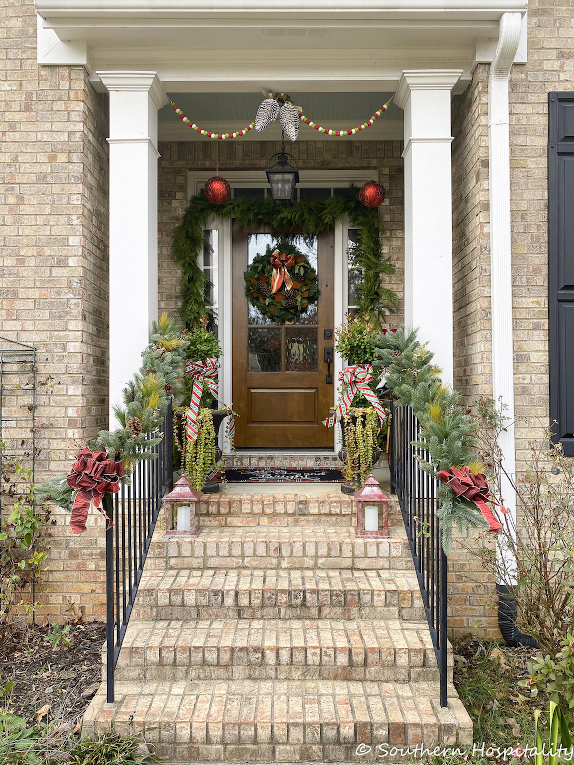 Front porch with rails decorated with garlands.