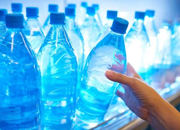 stocking bottled waters in the fridge