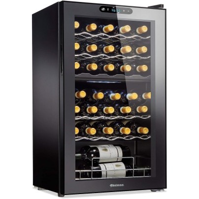 The Wine Enthusiast 32-Bottle Dual-Zone Max Wine Cooler fully stocked with wine and shown on a white background.