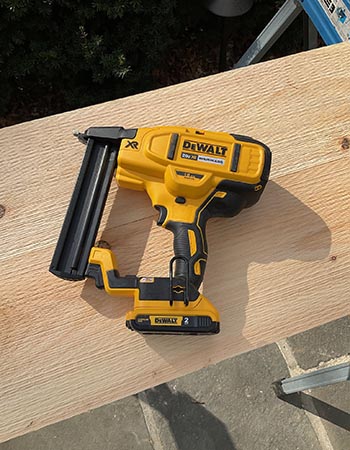 The DeWalt Crown Stapler on a piece of wood during hands-on testing.