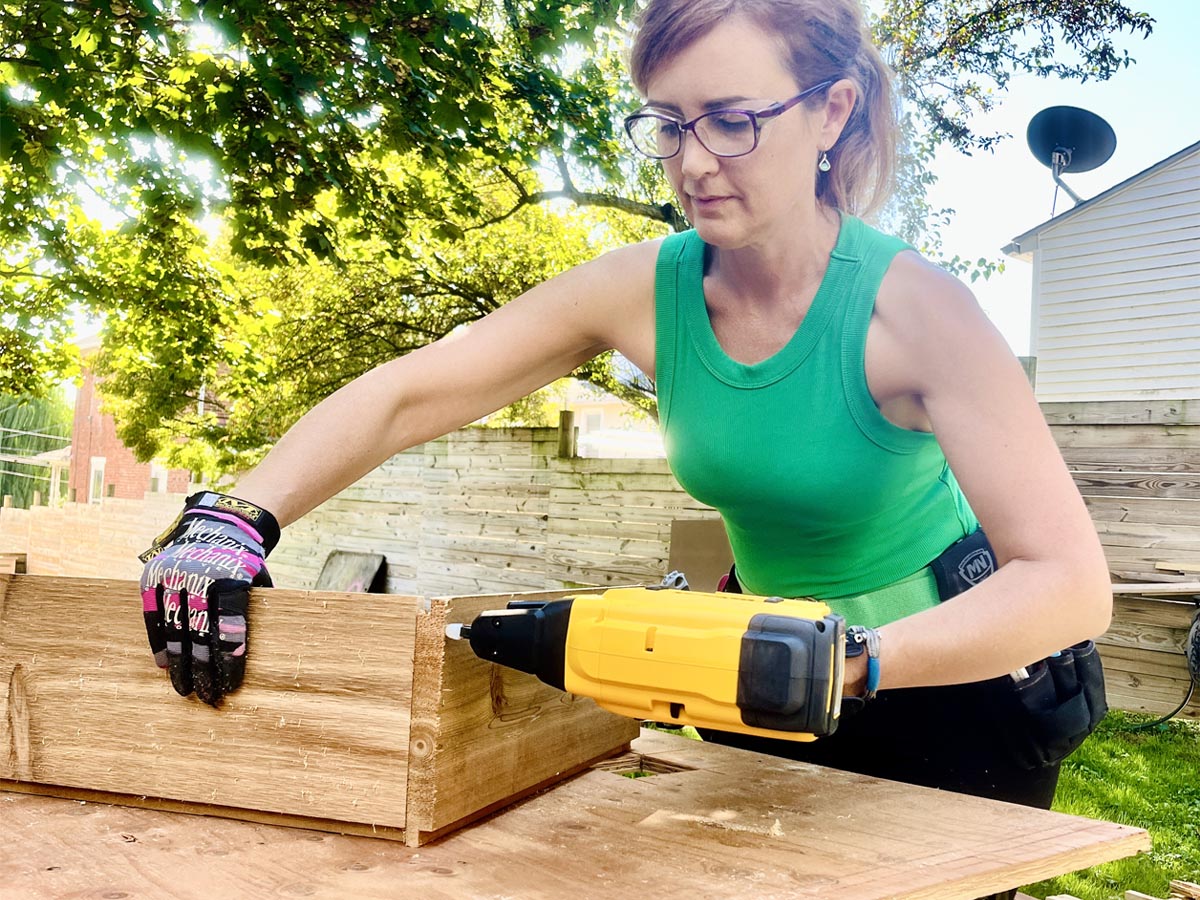 A person using the DeWalt Crown Stapler to fasten a piece of wood during a hands-on test.