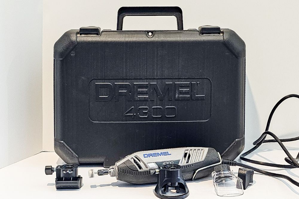Dremel 4300 rotary tool on white counter with included accessories and black storage case