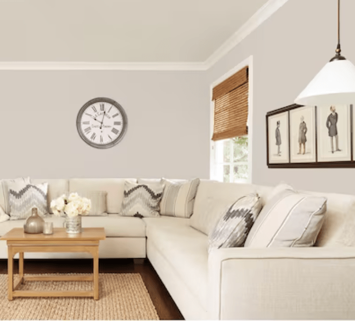 Living room with beige sectional sofa and walls painted in HGTV HOME by Sherwin-Williams' &ldquo;Agreeable Gray.&quot;