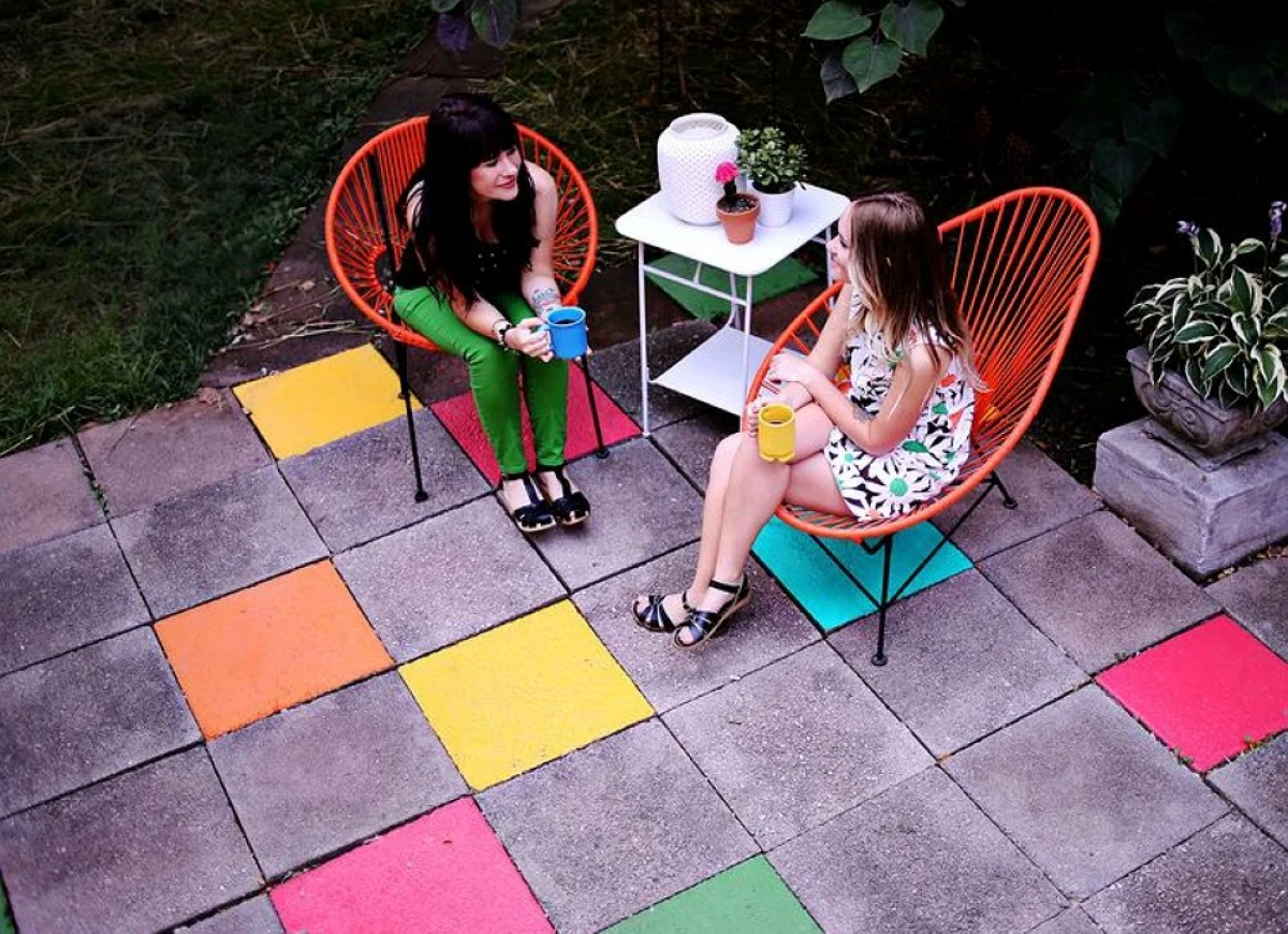 Backyard concrete patio with colorful squares.