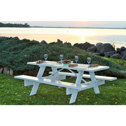 The Dura-Trel 6-Foot White Vinyl Patio Picnic Table set for an upscale picnic at a scenic overlook with a big body of water in the background.