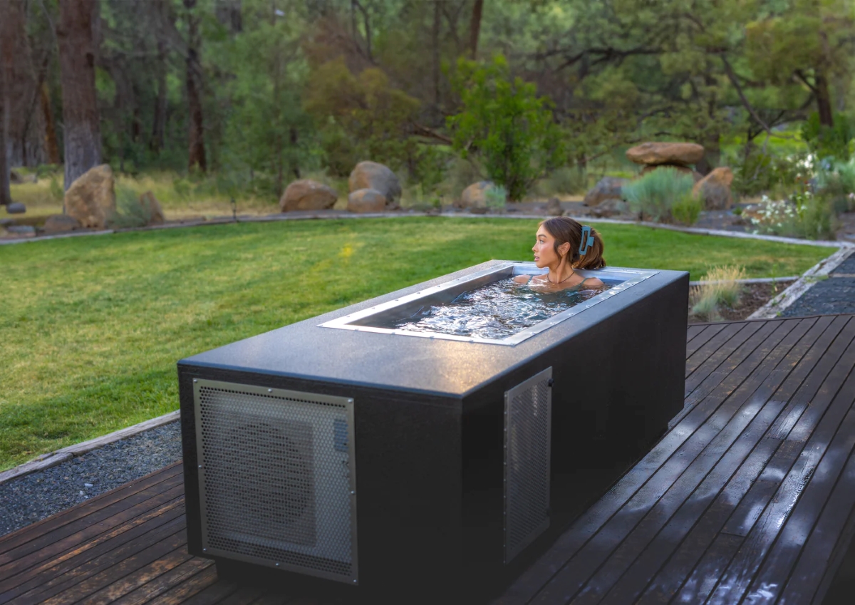 Woman in small rectangular cold plunge pool.