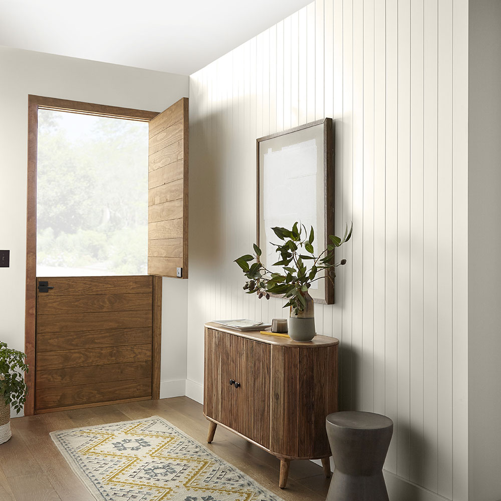 Entryway with wooden door in Behr's color of the year, "Blank Canvas."
