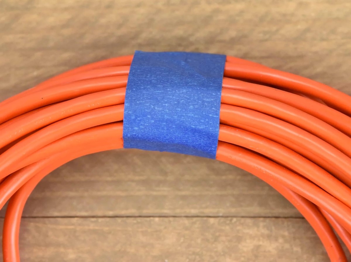 Blue tape around orange cord.