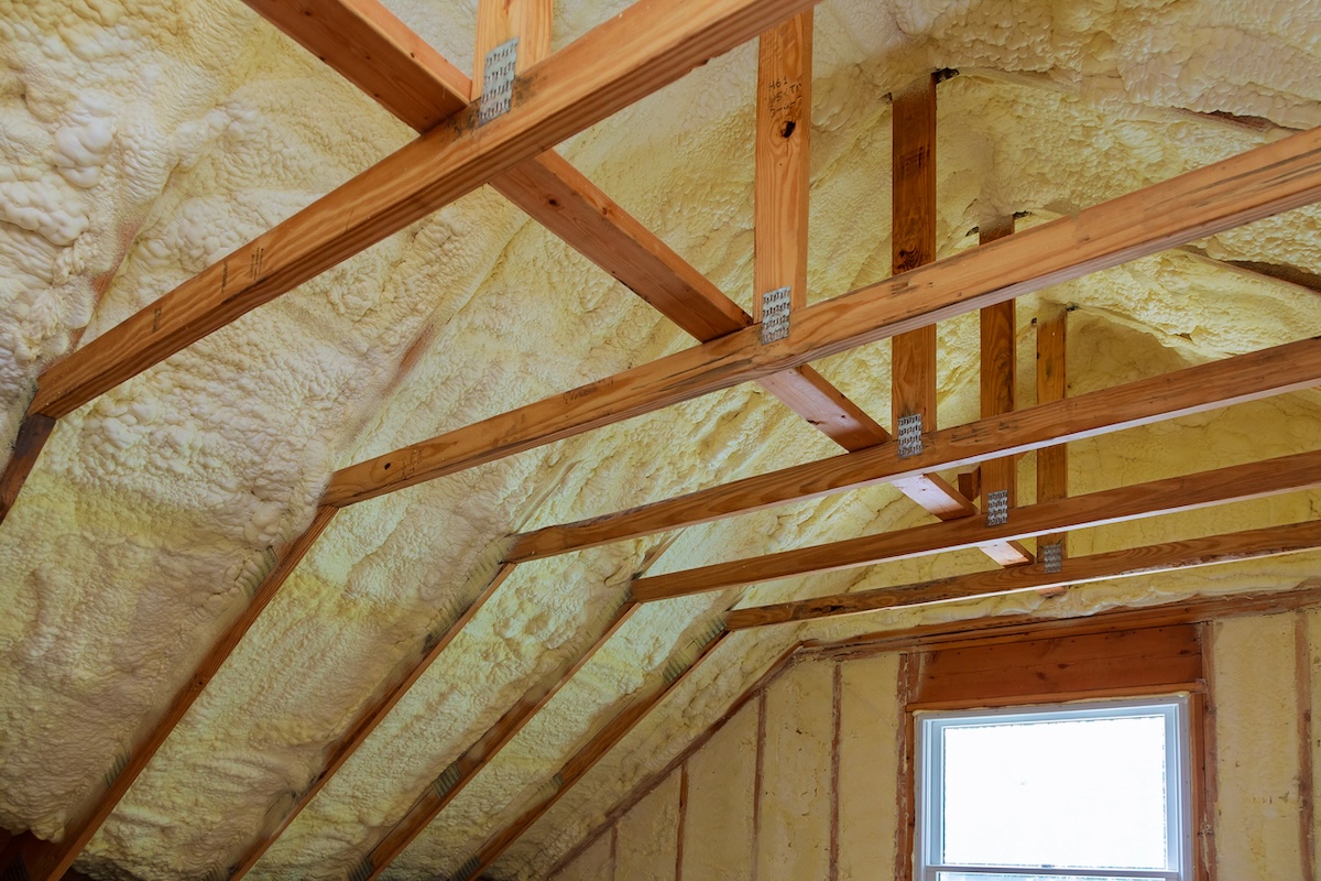 Spray foam insulation installed inside a home attic eligible for tax credits.