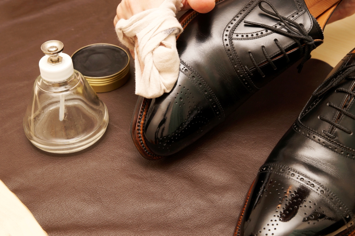 Person shining black shoes.
