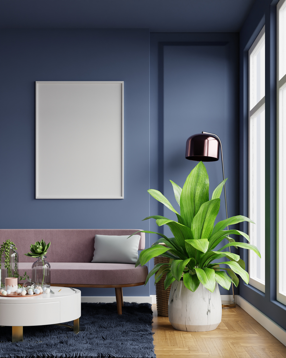Living room with mauve sofa and navy blue ceilings and walls with large window.