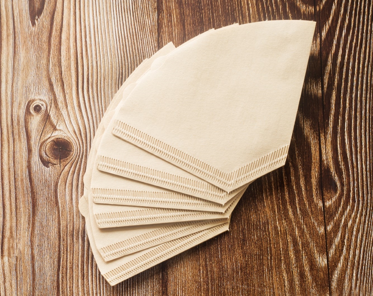 Coffee filters on wooden table.