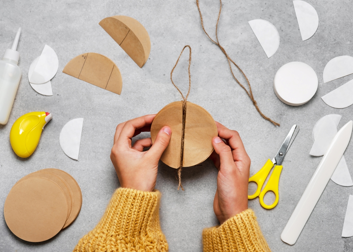 Person making crafts with coffee filter paper.